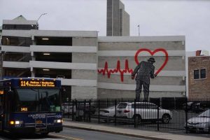 parking garage outside with a drawing of a man painting a heart